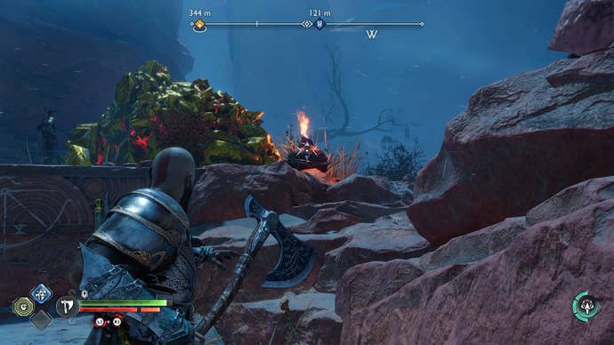 Kratos destroying a pile of golden rocks with a flaming pot in God of War Ragnarok