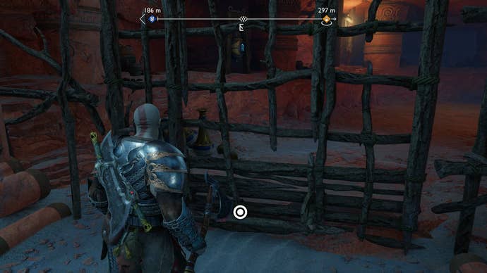 Kratos opening a wooden gate during Secret of the Sands in God of War Ragnarok