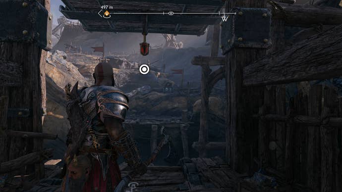 Kratos using his Blades of Chaos to swing across a gap in God of War Ragnarok