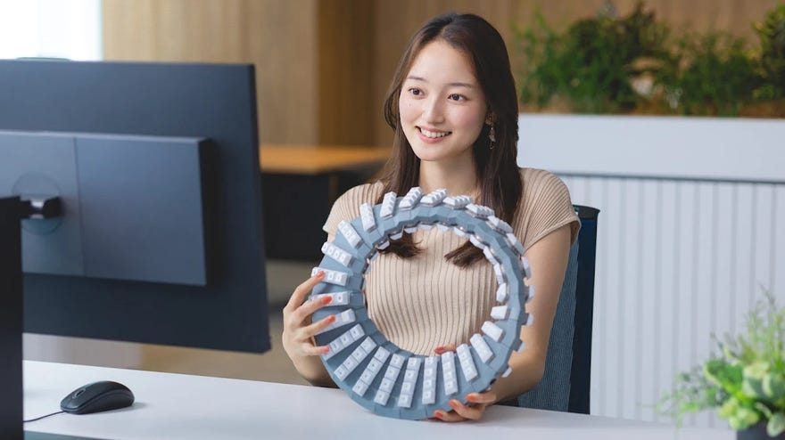 A woman holding Google’s novelty, double-sided Gboard keyboard.