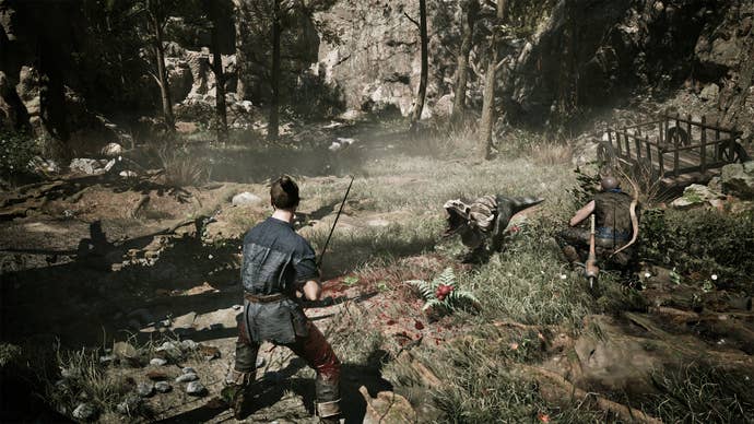 A Gothic Remake player brandishing a sword at a lizard monster in a sparse woodland area