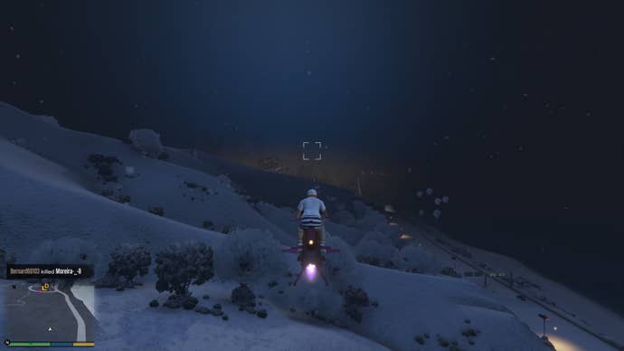 Flying over a dark snowy hillside in GTA Online.
