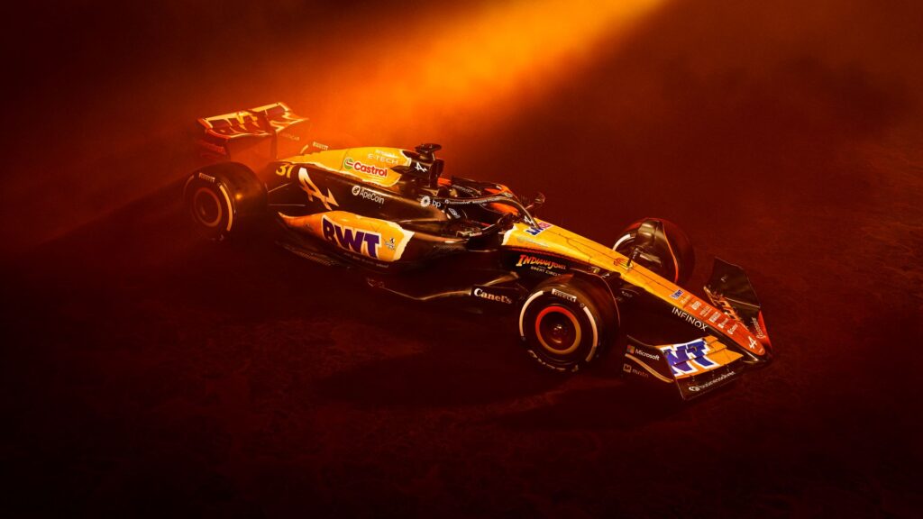Image of Indiana Jones-themed Alpine F1 race car in golden orange