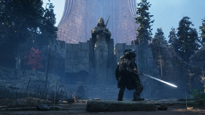 Rémi stands, sword in hand, in front of a large statue of a knight, which itself stands before a tower.