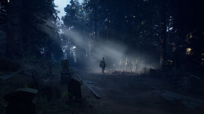 Rémi stands in front of three graves in a forest.