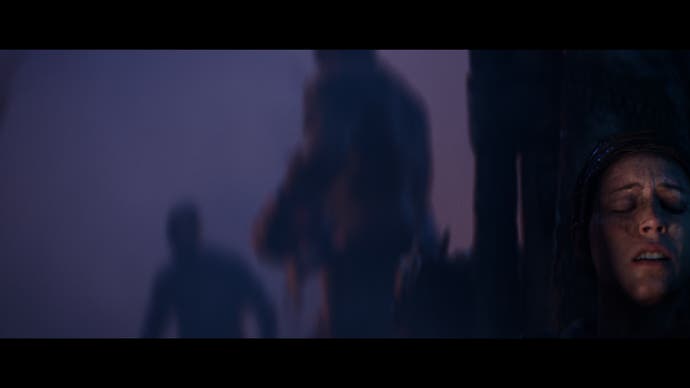 Hellblade 2 screenshot showing Senua hiding, visibly afraid, from two enemies