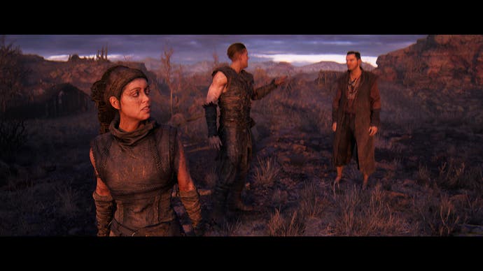 Hellblade 2 screenshot showing Senua standing to one side, listening to two characters argue