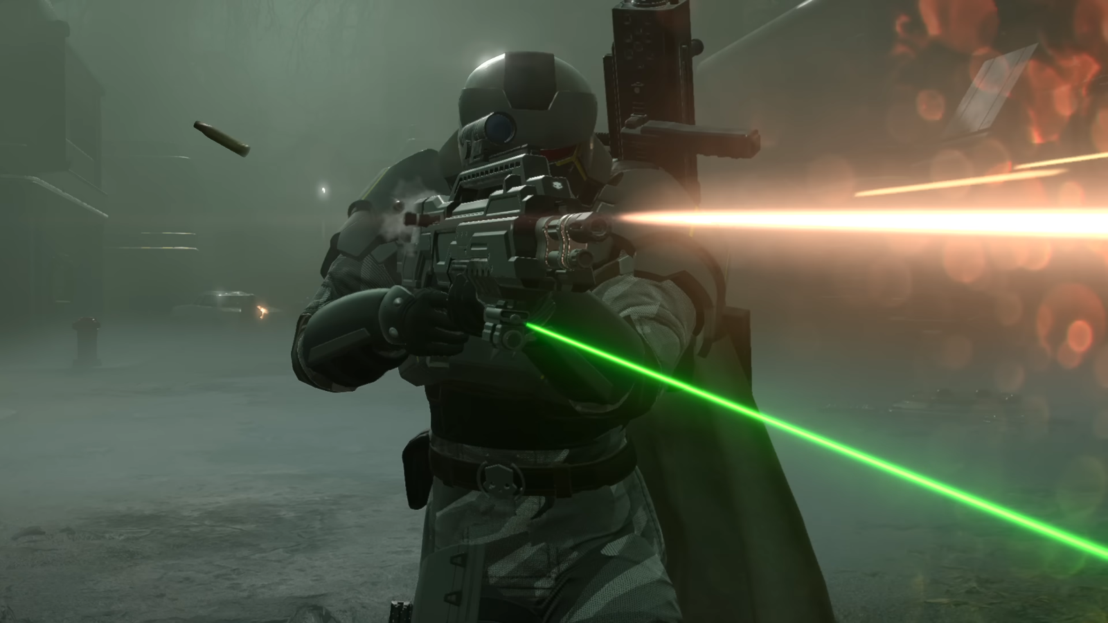 Helldivers 2 Omens of Tyranny trailer screenshot showing Helldiver character in all-black armour firing an assault rifle with a green laser sight