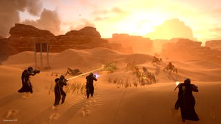 Helldivers 2 official screenshot showing a squad of four players advancing towards and shooting at a group of giant bugs on a desert planet.
