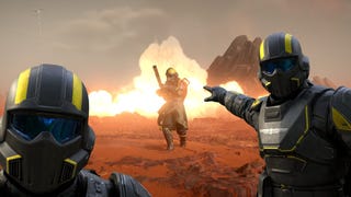 Helldivers 2 header image showing three Helldivers. The one on the right, as you look at the screen, is pointing back at the third Helldivers as an explosion burst behind them