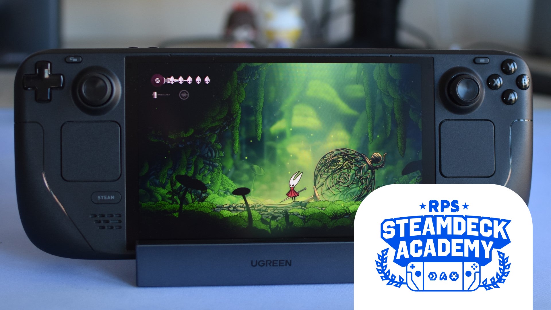 Hollow Knight: Silksong running on a Steam Deck OLED. The RPS Steam Deck Academy logo is added in the bottom right corner. - 1
