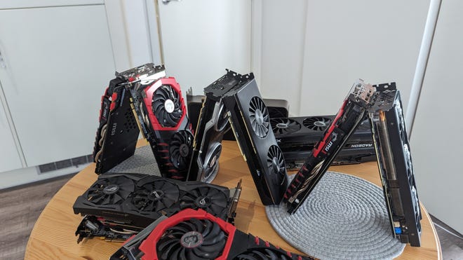 The bottom tier of the house of graphics cards, with six GPUs arranged into three pyramids.