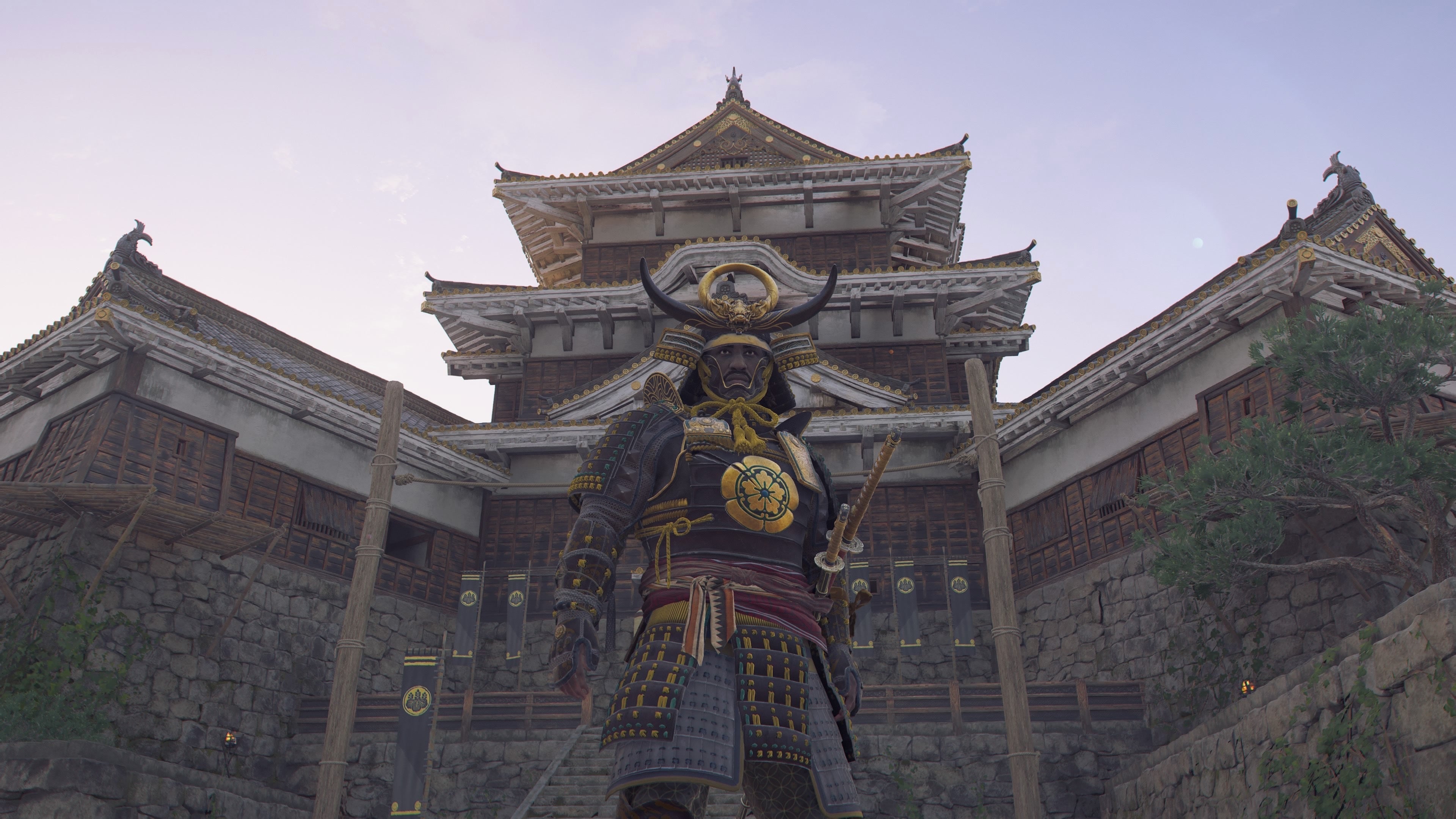 Yasuke standing below the highest tower of Yamazaki Castle in Assassin&rsquo;s Creed Shadows.