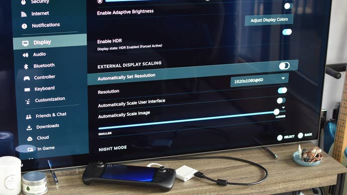Step 4 of how to connect a Steam Deck to a TV with an adapter: open the Steam Deck’s Display settings, uncheck “Automatically set resolution”, and select your TV’s native resolution.