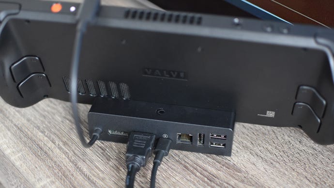 Step 1 of how to connect a Steam Deck to a TV with a docking station: connect the Steam Deck to the dock, then plug in HDMI, power, and gamepad or mouse/keyboard inputs. Plug the other end of the HDMI cable into your TV.