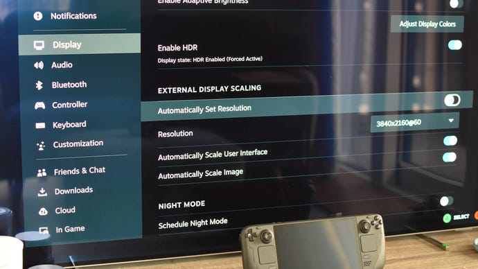 Step 3 of how to connect a Steam Deck to a TV with a docking station: Enter the Steam Deck's Display settings, uncheck 'Automatically set resolution', and select your TV's resolution.