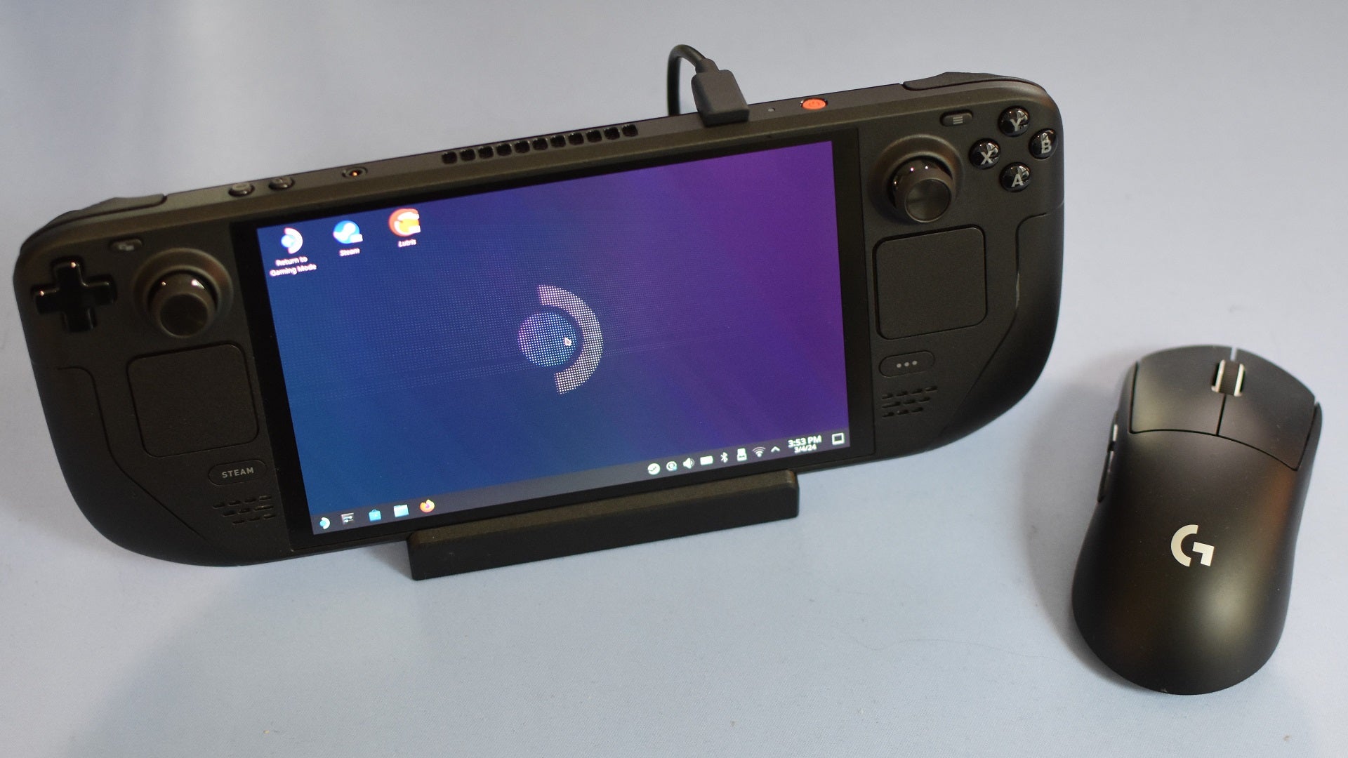 A Steam Deck, in Desktop Mode, docked and with a connected wireless mouse. - 5