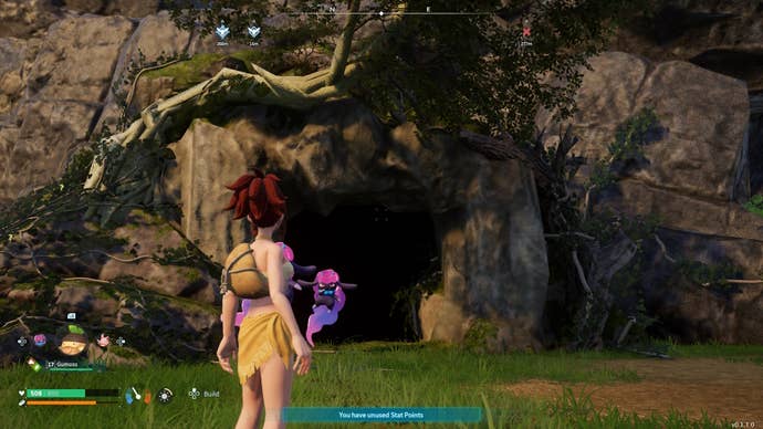 Looking at a dark cave in a grassy area in Palworld.