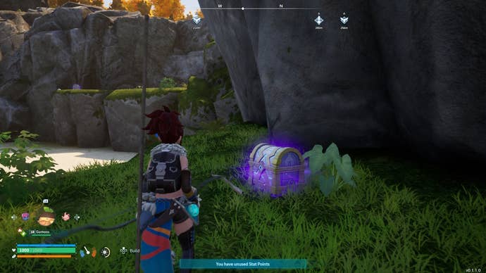 A blue glowing chest on a small cliff near a beach in Palworld.