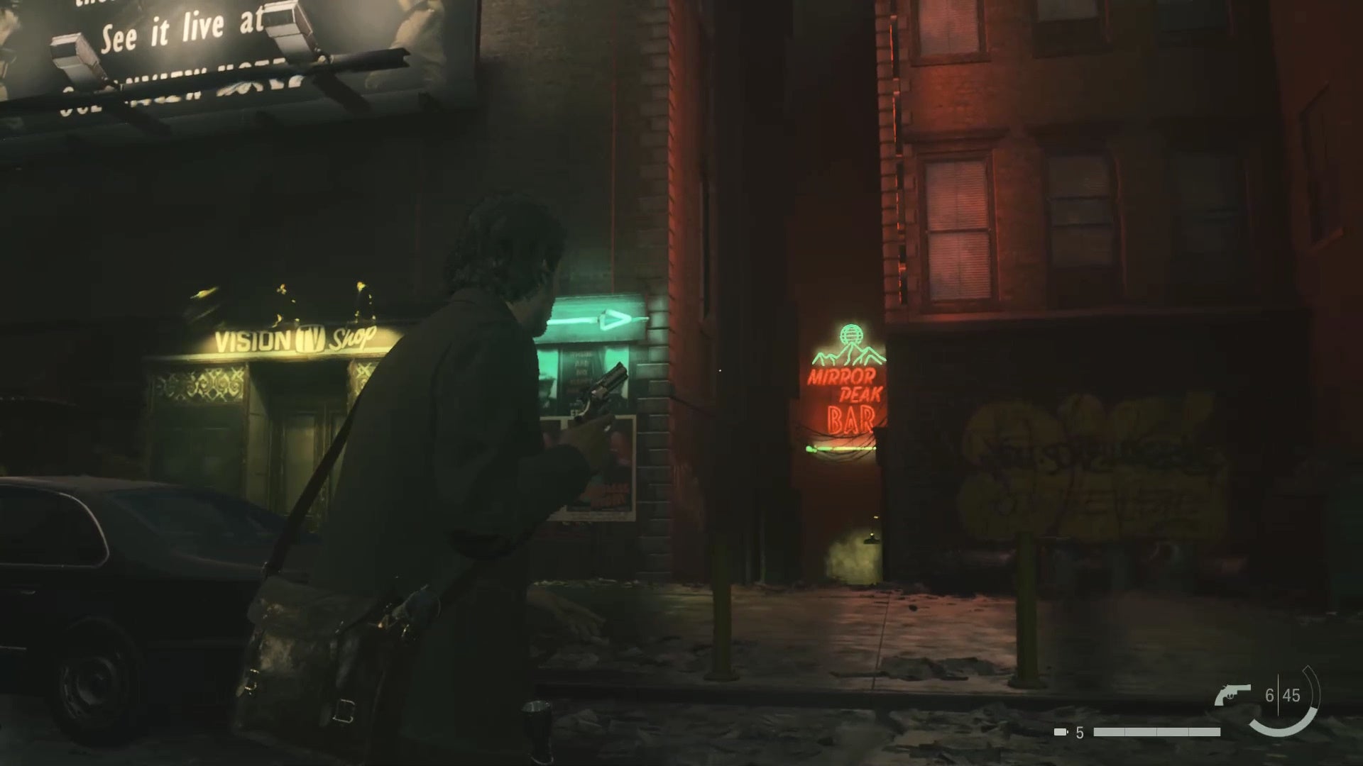 Alan with his revolver raised looking down an alleyway with a red and blue sign reading &lsquo;mirror peak&rsquo;, with a green arrow pointing to the alley beside a shop selling televisions