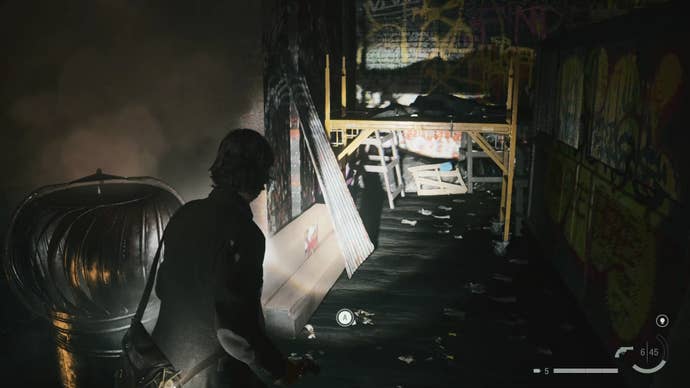 alan shining his flashlight on construction work on a rooftop, with a gap below a yellow object