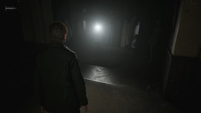 James watches the bright light of the flashlight on a fashion doll in a dark room in Silent Hill 2.