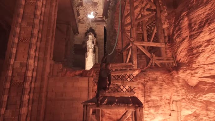 Using the Grappling Hook to swing across an indoor chasm in Enshrouded.