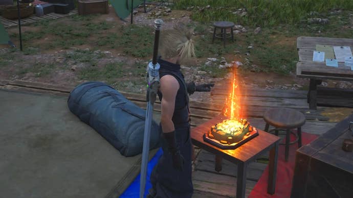 Cloud stretching his left hand over the Fort Condor board game at Encampment Vestiges in Final Fantasy 7 Rebirth.