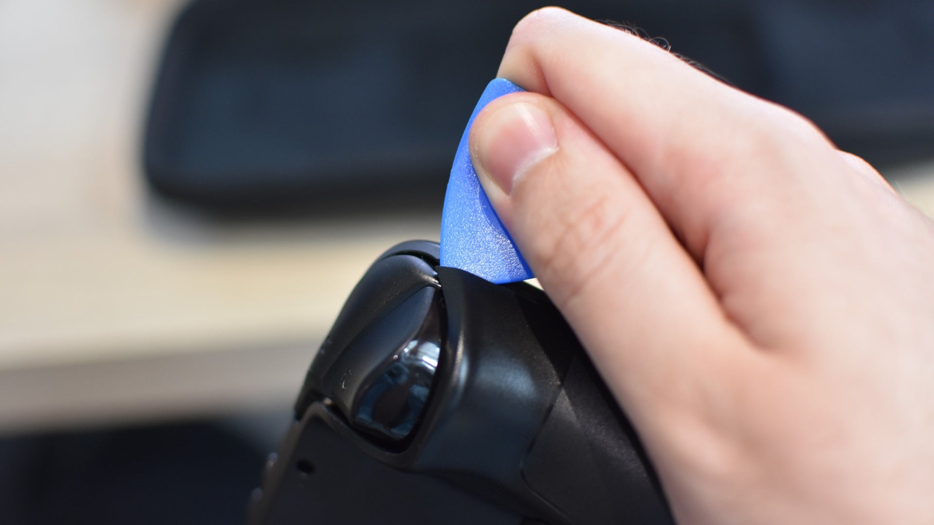 Step 3 of how to install an SSD in a Steam Deck: remove the Steam Deck's back cover, ideally with the aid of a plastic pry tool. - 8