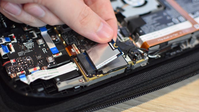 Step 6 of how to install an SSD in a Steam Deck: Remove the screw holding the SSD in place and gently pull it out opf the M.2 slot.