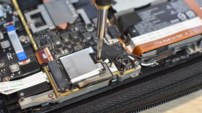Step 8 of how to install an SSD in a Steam Deck: Insert the new SSD and use the screw you just removed to fasten it in place.