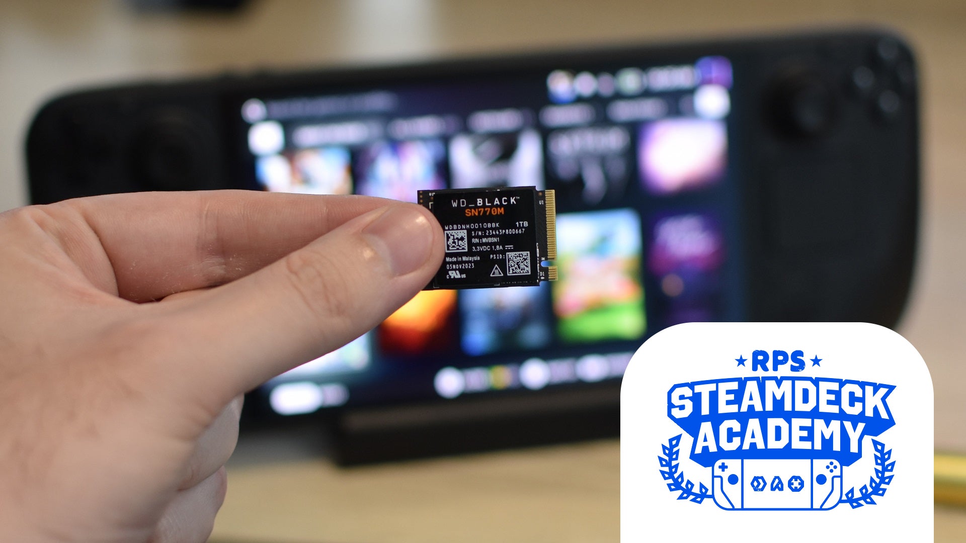 A WD Black SN770M SSD held up in front of a Steam Deck. The RPS Steam Deck Academy logo is added in the bottom-right corner. - 1