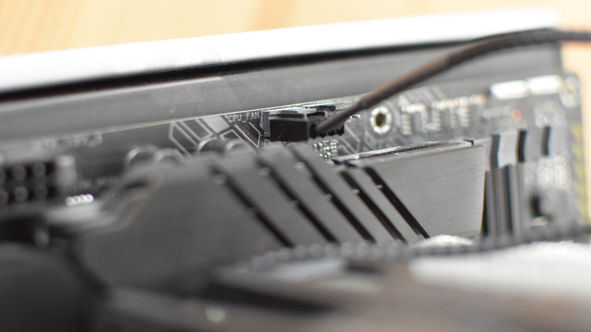 Step 5 of how to install a CPU air cooler: connect the cooler cable to the motherboard&rsquo;s CPU_FAN header.