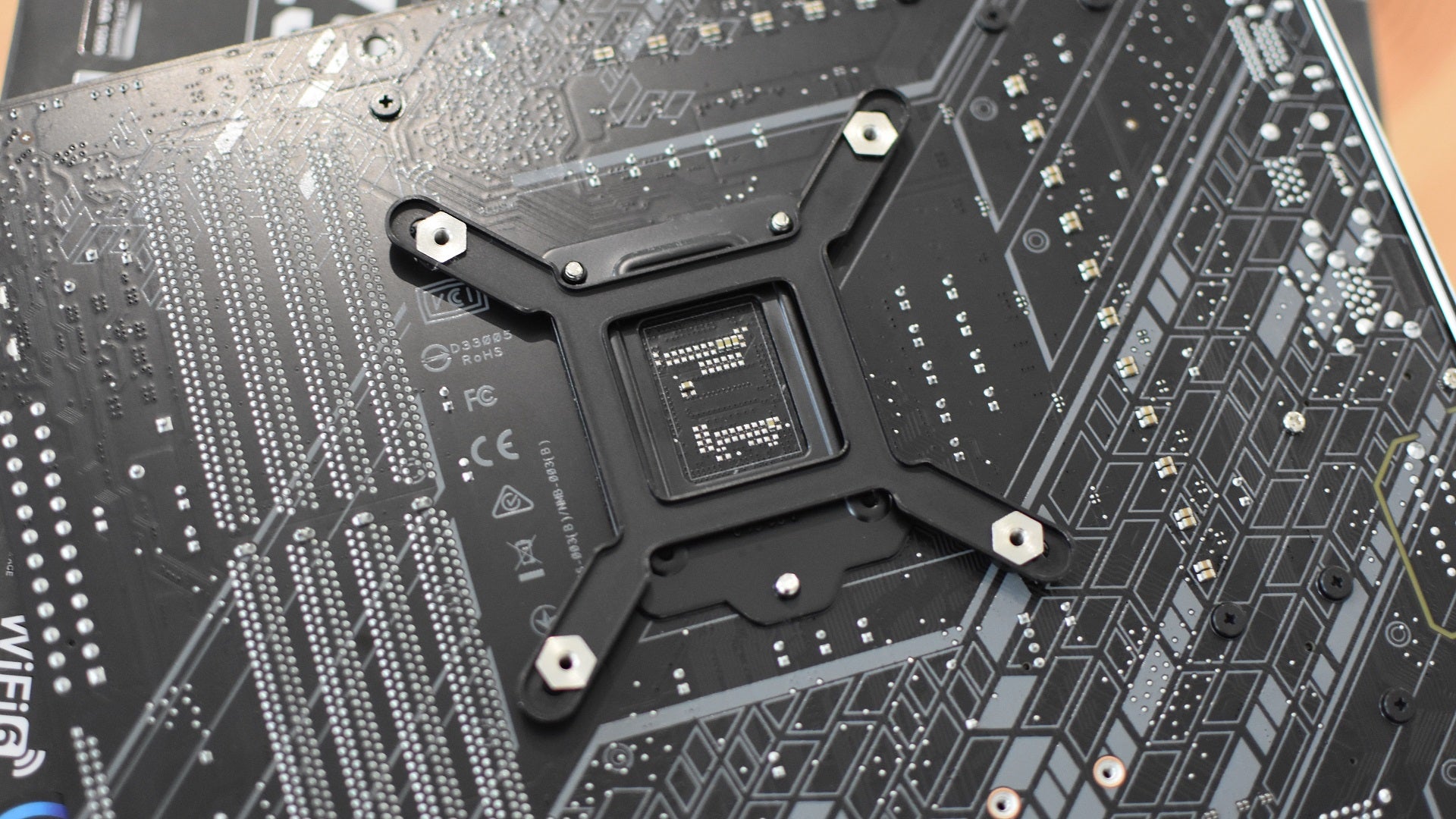 Step 1 of how to install a CPU liquid cooler: Assemble the backplate.