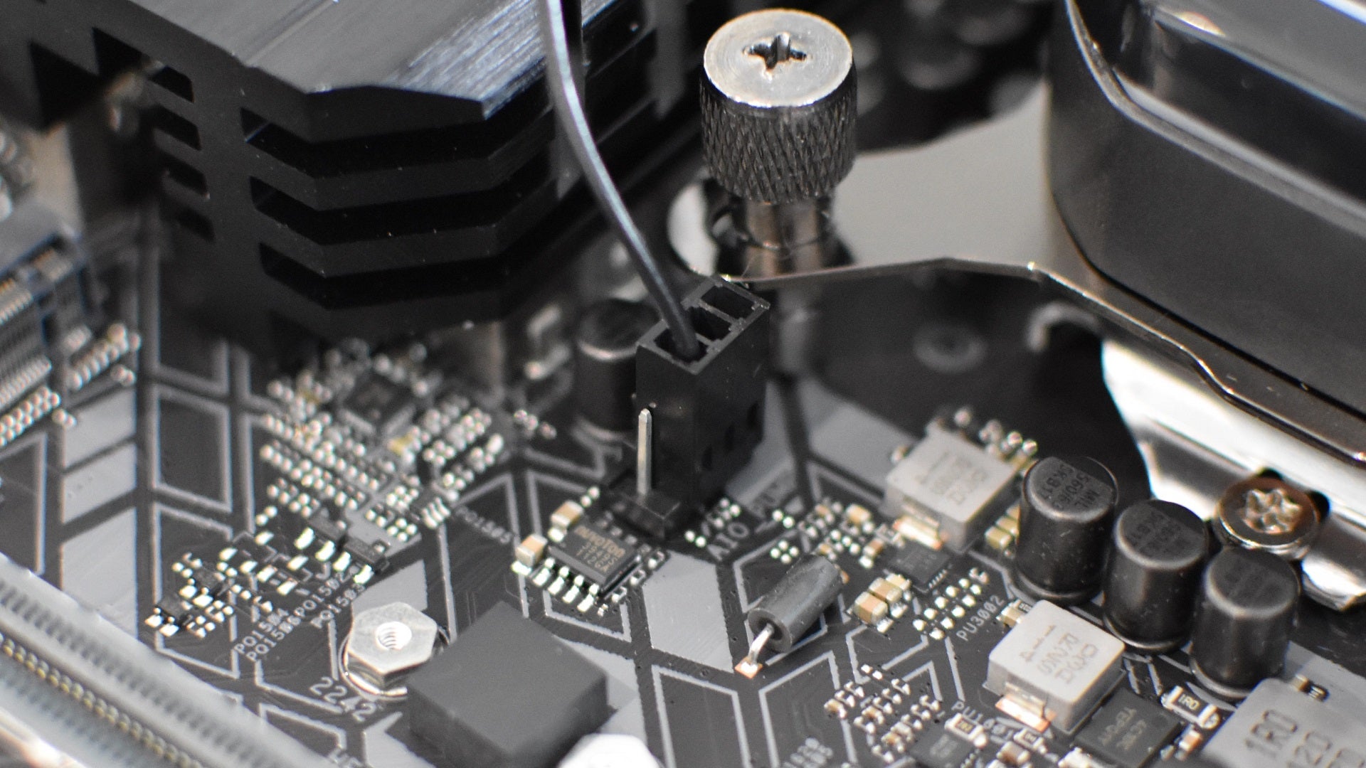 Step 5 of how to install a CPU liquid cooler: connect the cooler&rsquo;s pump cable to the motherboard.