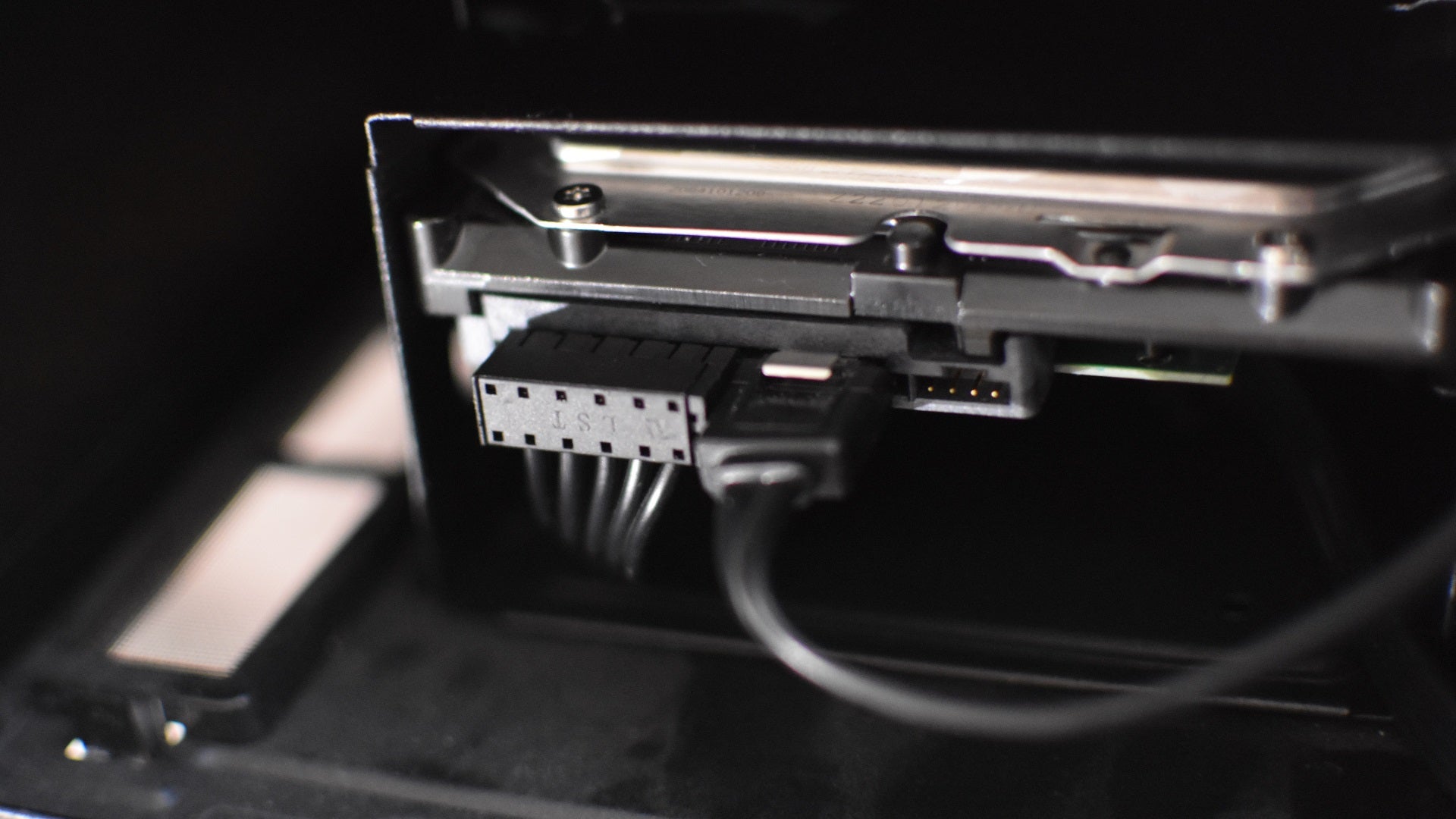 Step 4 of how to install an internal HDD: Connect SATA power and data cables to the edge of the HDD.