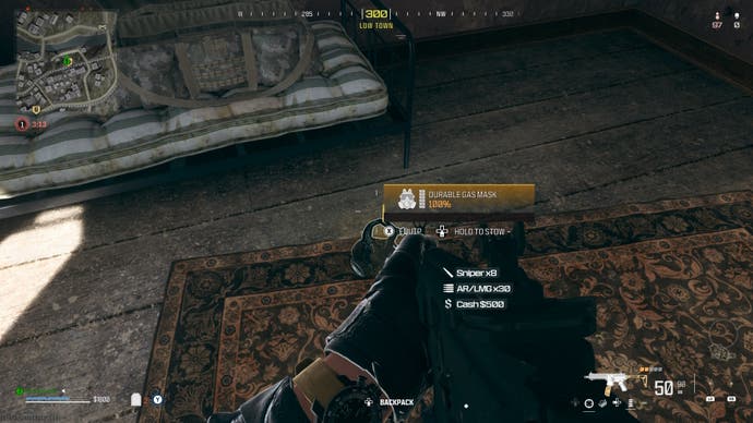 looking at a gas mask on a carpet in a house on the urzikstan map with the option to equip or stow displayed