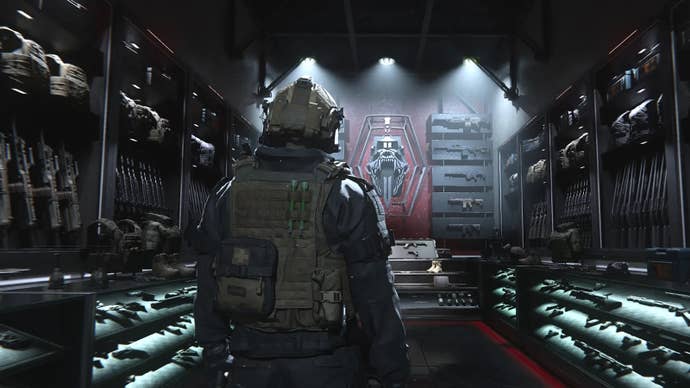 a soldier viewed from behinf looking at a room stacked with guns and military equipment on the walls