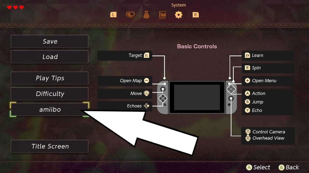 A white arrow pointing to thr Amiibo option in the System menu of Zelda Echoes of Wisdom.