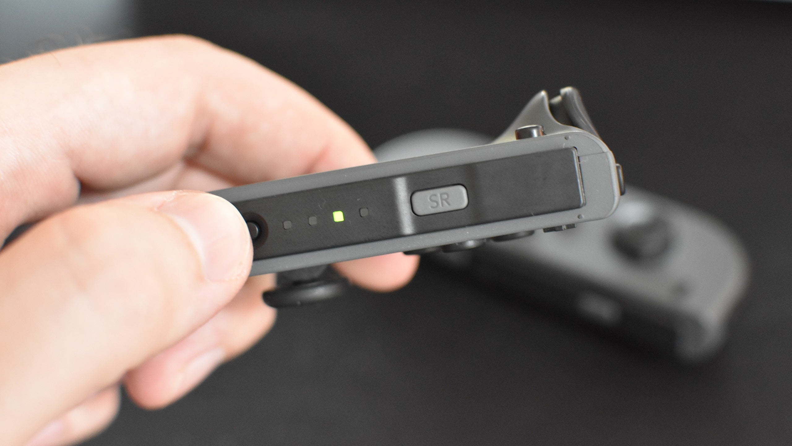 Step 2 of how to use Nintendo Joy-Cons on PC: Holding the Sync button on each Joy-Con until they enter pairing mode.