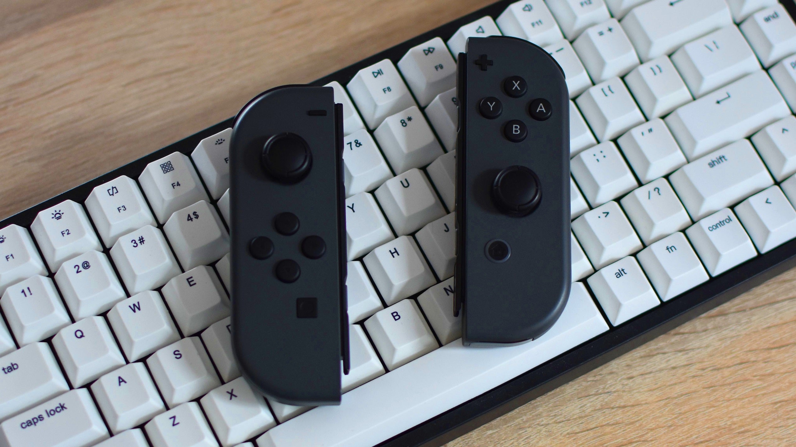 A set of Nintendo Joy-Cons resting on a keyboard.