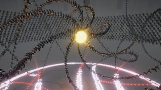 Screenshot from Humanity showing a spiralling cascade of people around a yellow glowing epicentre