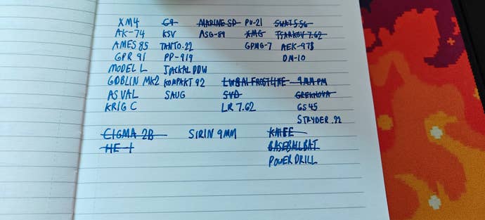 A real-life, lined notebook. In blue ink we see an orderly list of gun names, with some of the names crossed out. It’s Will Judd’s gun-collection list from Black Ops 6.