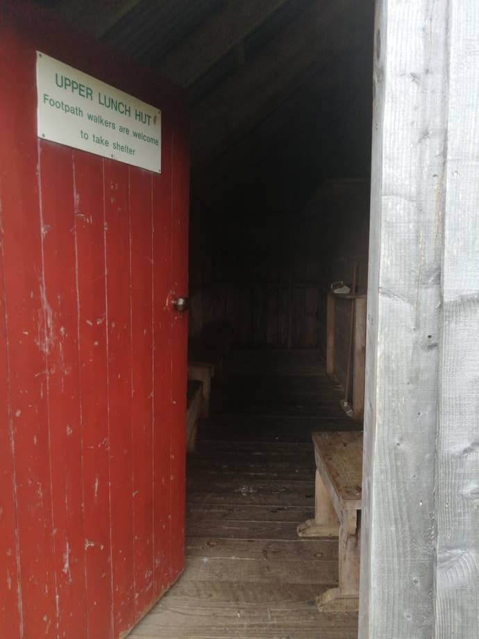 A close-up of the open door to a wooden hut for hikers in Scotland