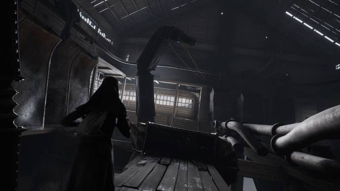 Indika runs through a factory while being pursued by a creature in Indika
