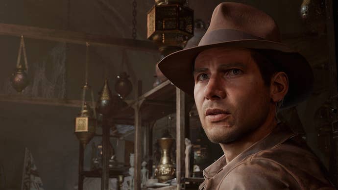 Indiana Jones and The Great Circle promo screenshot showing Indy in close up in front of some dusty shelves of old artefacts