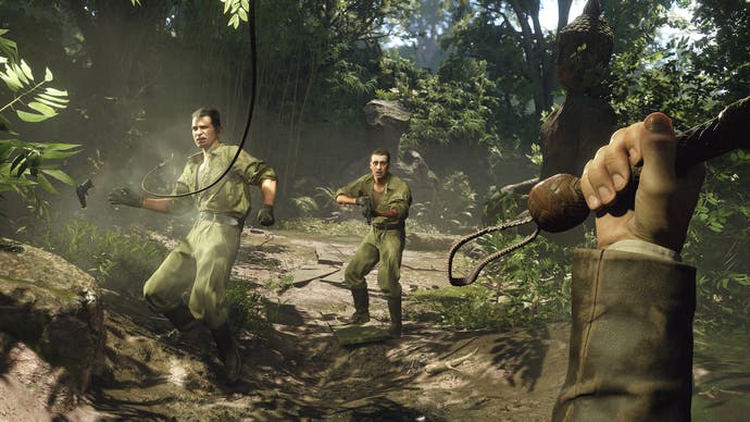 Indiana Jones and The Great Circle promo screenshot showing Indy whipping some bad guys in first person in the jungle