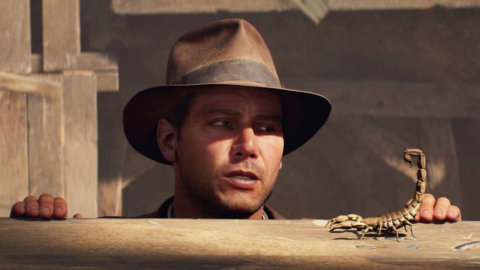 Indy pops his head over a ledge to see a scorpion in Indiana Jones and the Great Circle