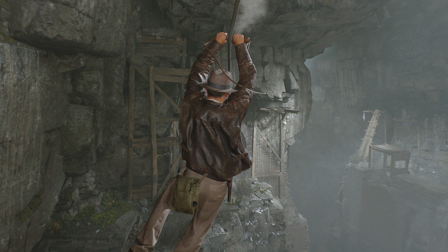 Indy uses his whip to zipline over to a new ledge in Indiana Jones and the Great Circle's Order of Giants DLC