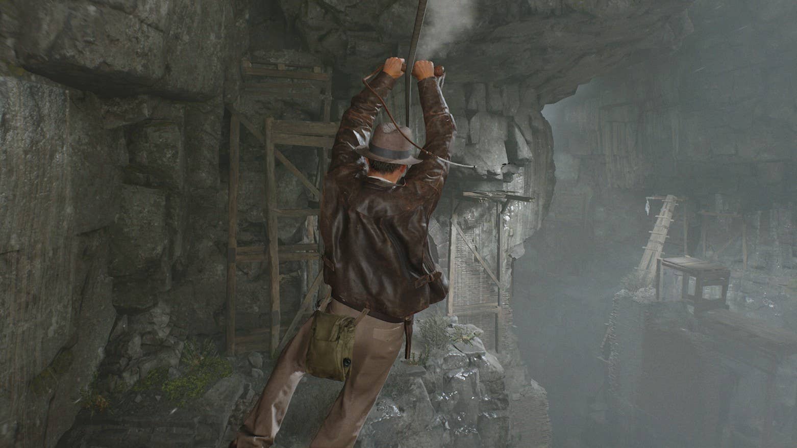 Indy uses his whip to zipline over to a new ledge in Indiana Jones and the Great Circle's Order of Giants DLC